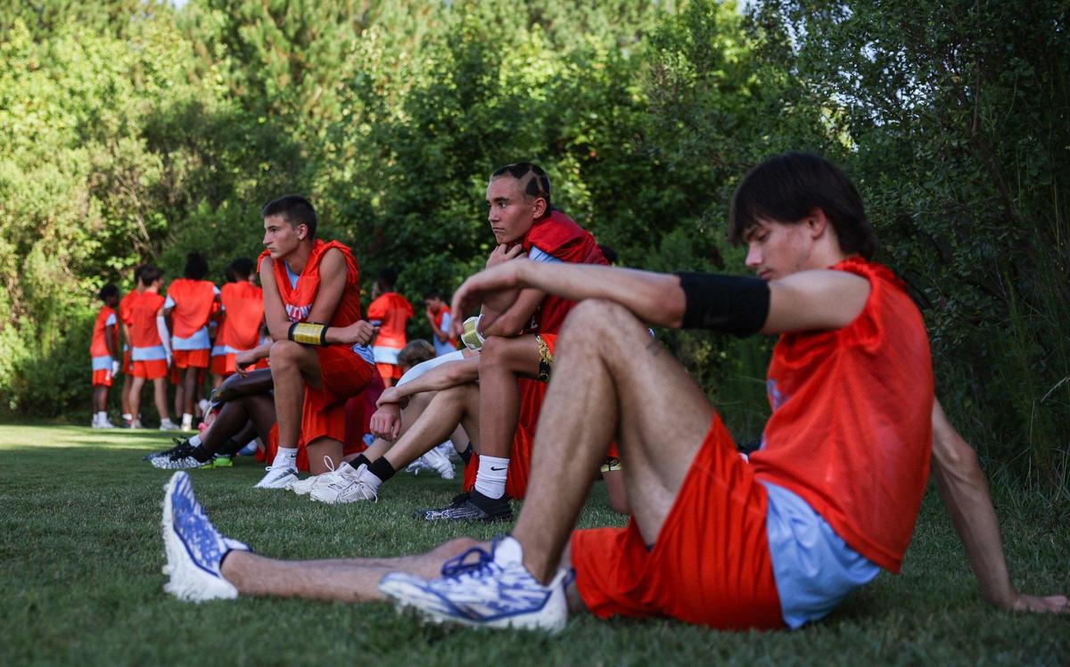 Players take a break in the shade as they tryout for Ballantyne Ridge, a new high school opening this year in south Charlotte, during tryouts for its inaugural football team on Thursday, July 11, 2024. The team’s first game will be this Friday, August 23rd against Fort Mill.