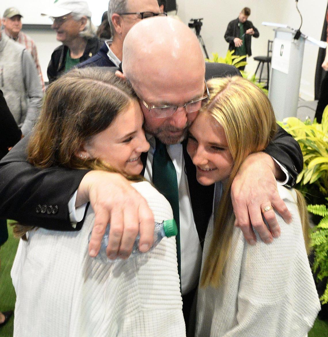 New Charlotte 49ers head football coach got a surprise Monday when Quinn Haines, 14, and Blair Haines, 16, the daughters of a former coaching colleague, Brian Haines, made the trip from Boone with their mother, Mary Haines (not in photo).