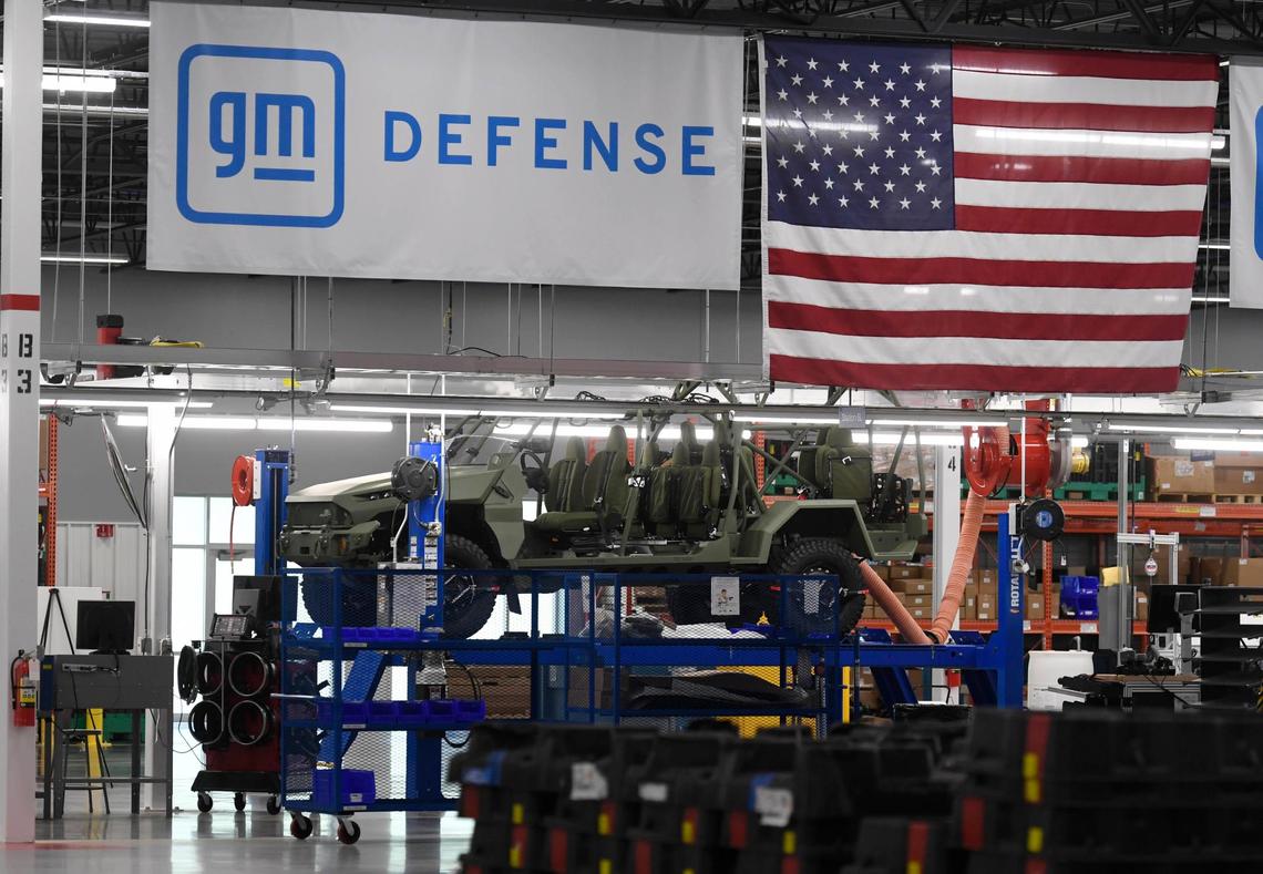 Flags hang above the the assembly line of the new Infantry Squad Vehicle built at the GM Defense facility in Concord, NC.