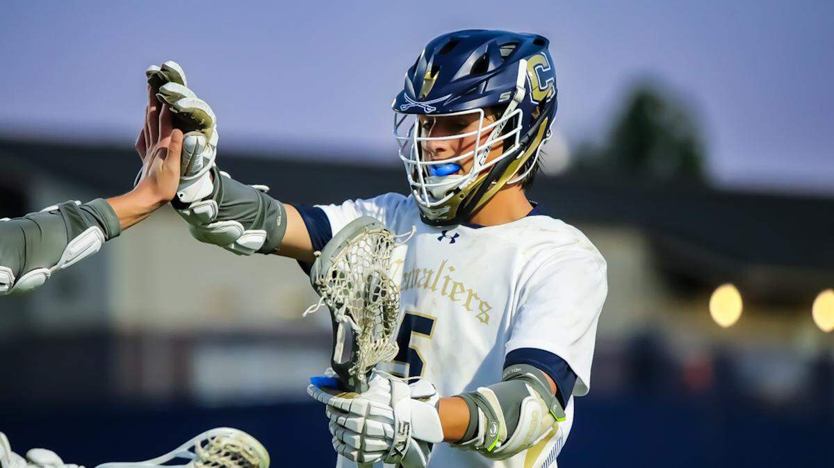 Cuthbertson senior Dominic Ciacco high fives his teammate after scoring against South Meck at the first round NCHSAA lacrosse playoffs at Cuthbertson HighSchool