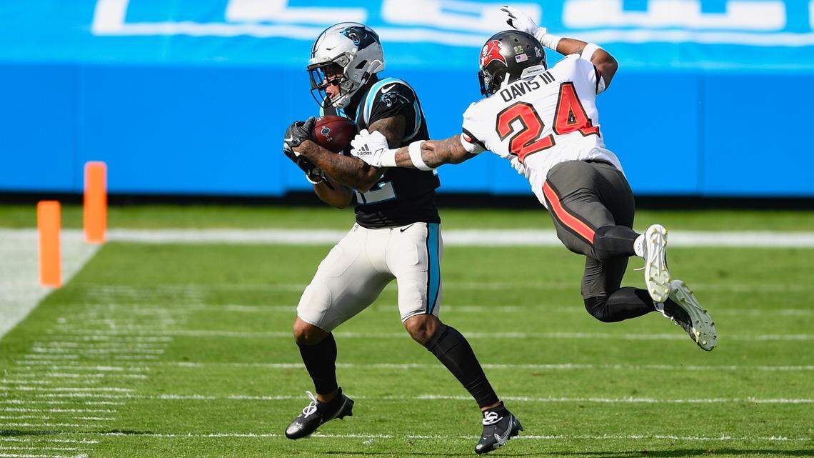 Carolina Panthers wide receiver D.J. Moore (12) makes a catch against Tampa Bay Buccaneers cornerback Carlton Davis (24) during the first quarter at Bank of America Stadium in Charlotte, NC on Sunday, November 15, 2020.