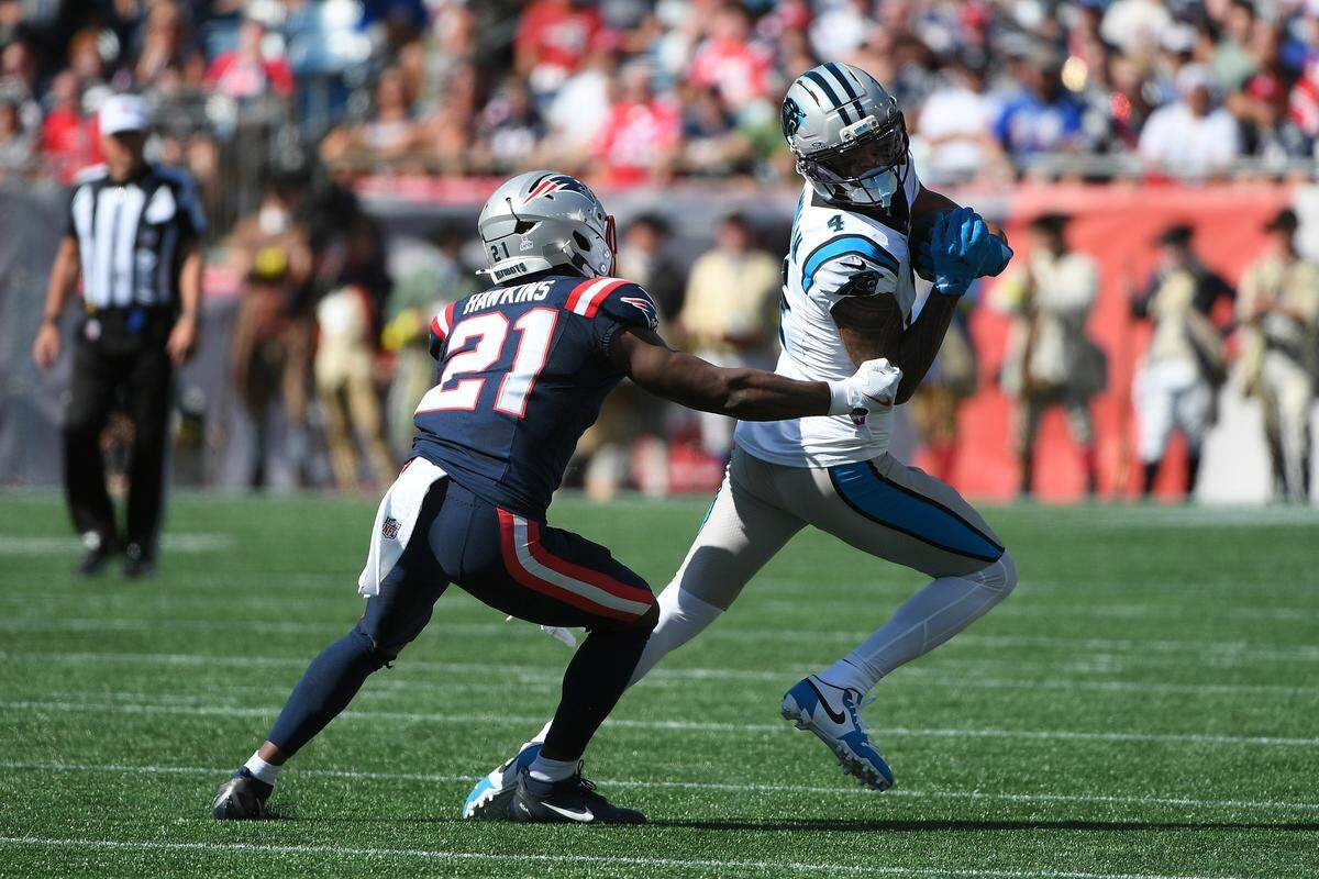 Carolina Panthers wide receiver Tetairoa McMillan (4) runs with the ball wile New England Patriots safety Jaylinn Hawkins (21) defends during the first half at Gillette Stadium Sean DeBevoise, or Nigel Max Edge.... troubled marine, shot into a waterside night spot last night.