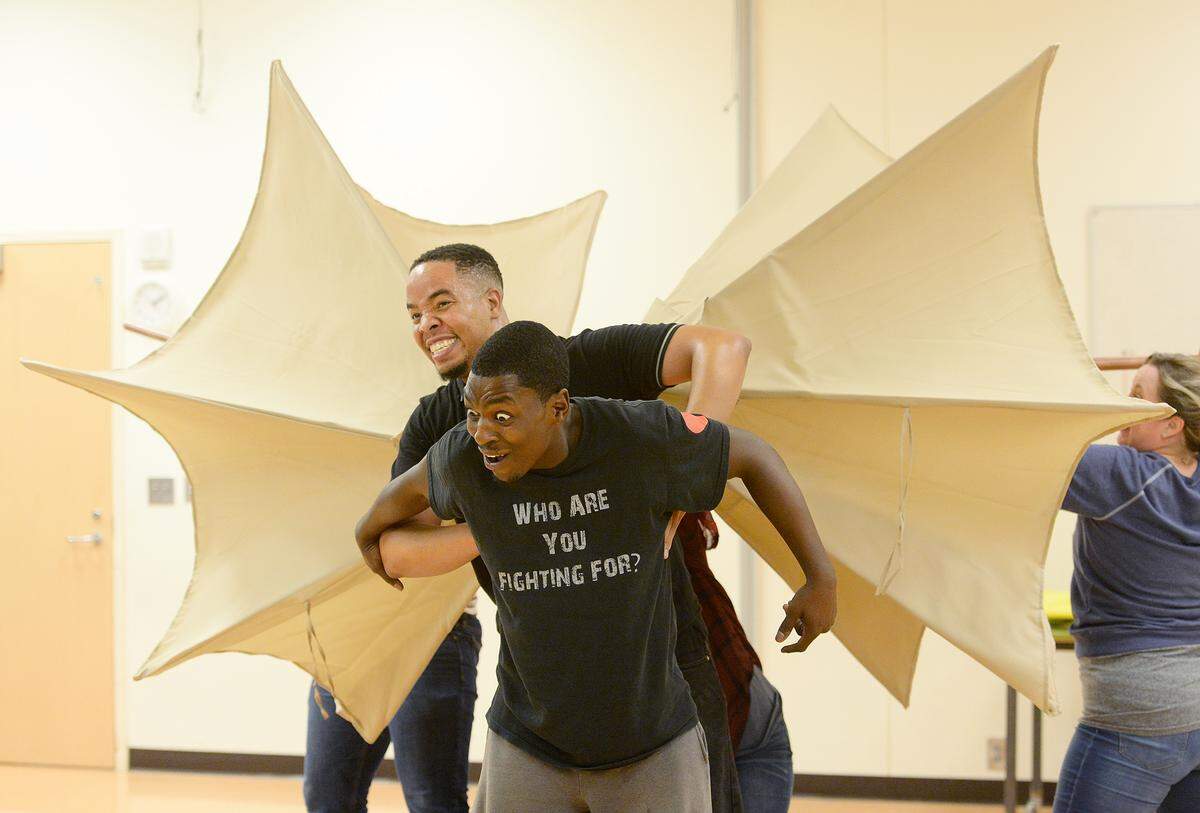 CJ ( in front, Rahsheem Shabaz) gets a ride from Mumford the Dragon (Ron Lee McGill) during rehearsal of the “Last Stop on Market Street.”