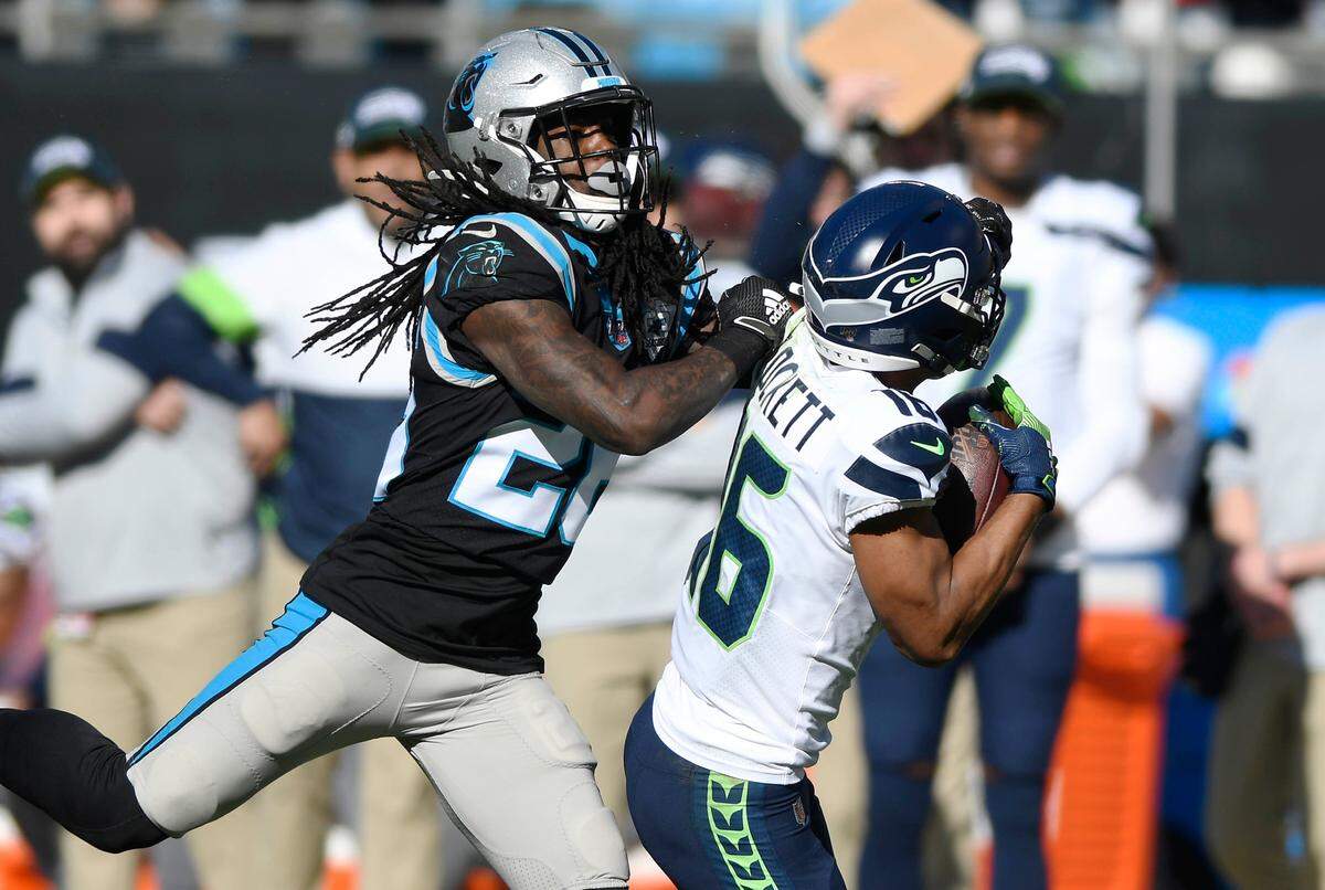 Seattle Seahawks wide receiver Tyler Lockett (16) makes a long reception past Carolina Panthers cornerback Donte Jackson (26) during the first half at Bank of America Stadium on Sunday, December 15, 2019.