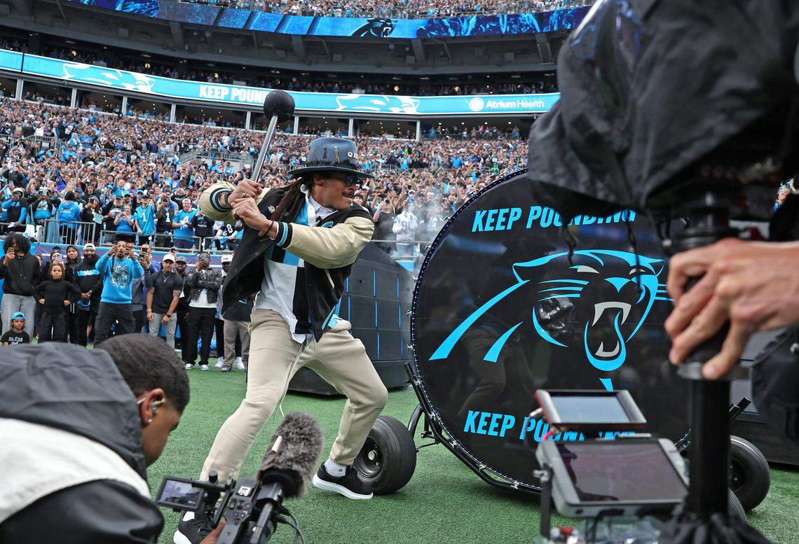 Former Carolina Panthers quarterback Cam Newton hits the Keep Pounding drum prior to the team's game against the Los Angeles Rams at Bank of America Stadium on Saturday, January 10, 2026. The Rams defeated the Panthers 34-31.