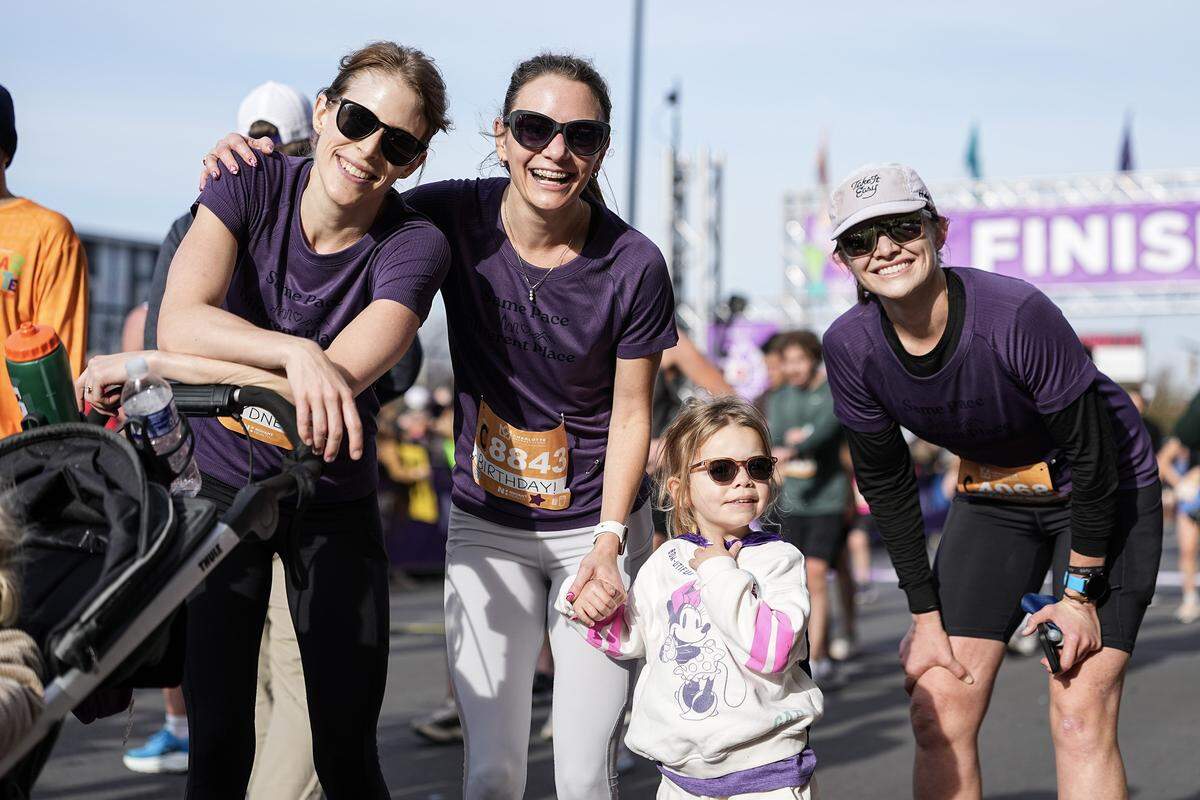 Participants pose for a photo after competing in the Novant Health Charlotte Marathon Saturday, Nov. 15, 2025, in Charlotte, N.C.