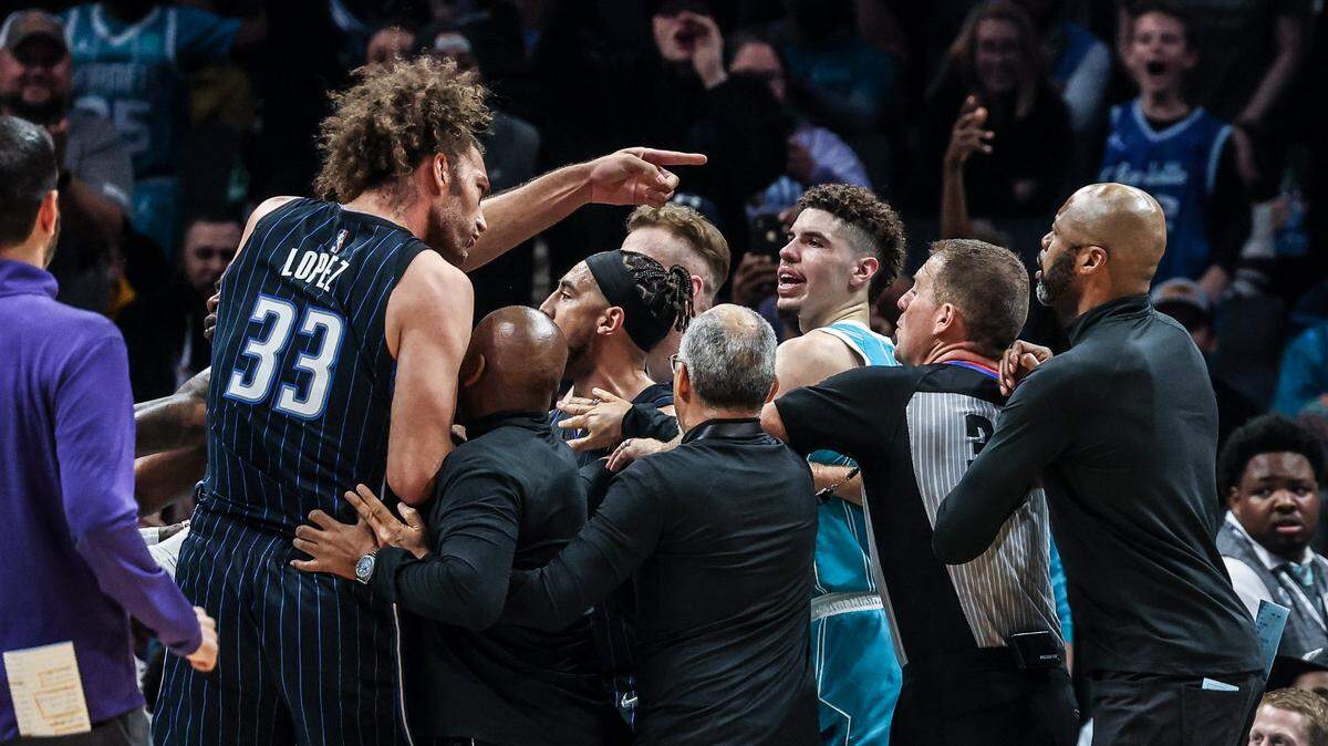 A tussle breaks out during the Charlotte Hornets and Orlando Magic game at the Spectrum Center in Charlotte, N.C., on Thursday, April 7, 2022, as Orlando’s Robin Lopez (33) gestures. Lopez would be ejected from the game.