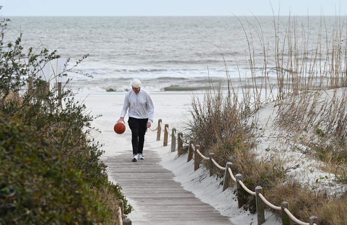 Former college basketball coach Bobby Cremins dribbles a ball up a boardwalk in Hilton Head, S.C. Cremins was a guard at South Carolina from 1967-70, nicknamed “Cakes” because, he said, “everybody thought that I talked like I had cake in my mouth.”