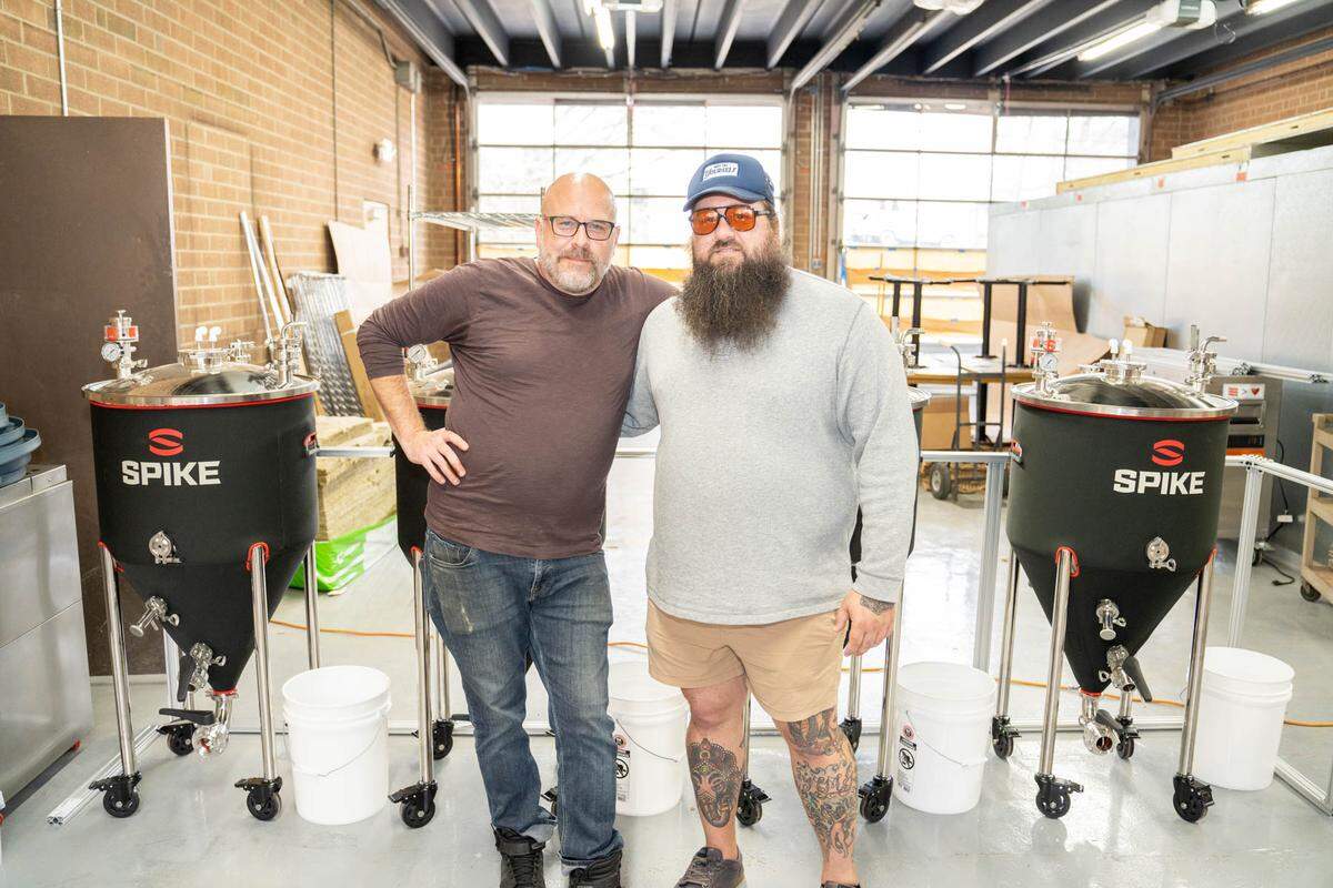 Owner Scott Blackwood and beverage/service manager Rob Florio pose with a set of Spike home brewery systems inside Firehawk in Mount Holly.