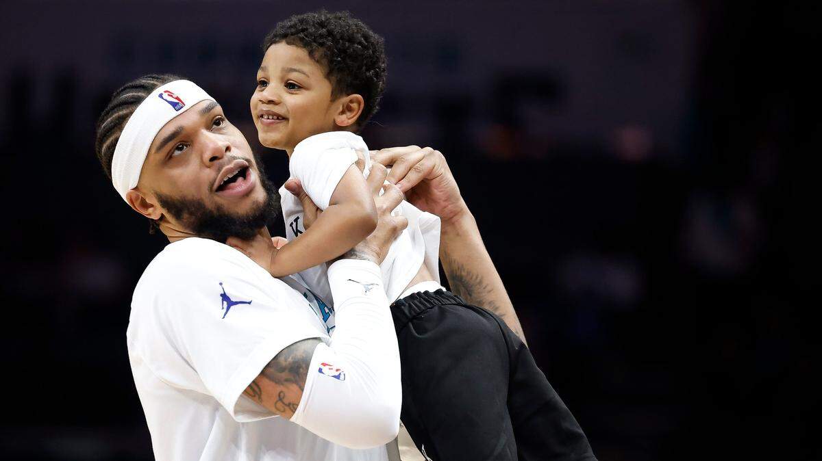 Charlotte Hornets forward Miles Bridges (0) hugs his son, Ace, before a game against the Dallas Mavericks at Spectrum Center last month. Bridges will hit restricted free agency this summer.
