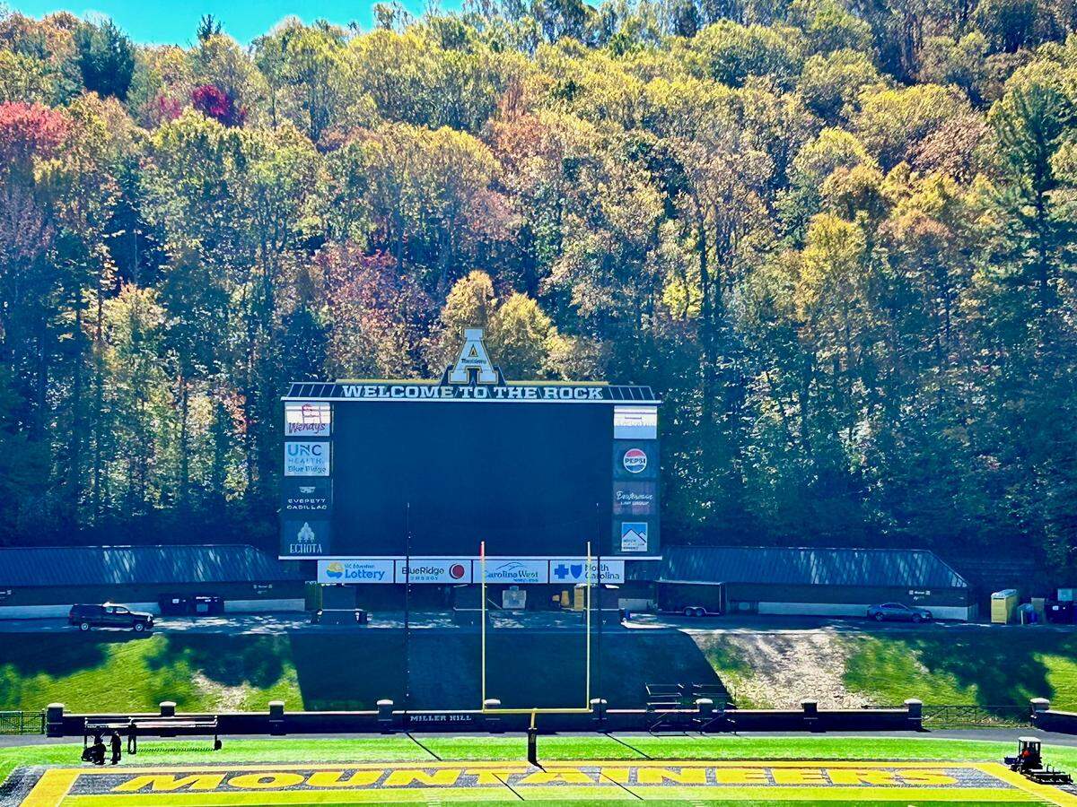 Appalachian State’s football scoreboard at “The Rock” is surrounded by trees beginning to change color on Oct. 21, 2024.