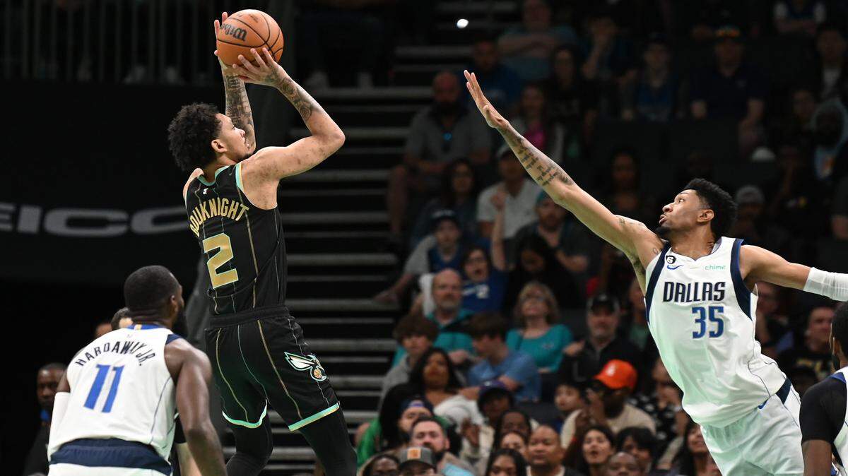Charlotte Hornets guard James Bouknight, left, releases a jump shot during second half action against the Dallas Mavericks at Spectrum Center in Charlotte, NC on Sunday, March 26, 2023. The Charlotte Hornets defeated the Dallas Mavericks 110-104.