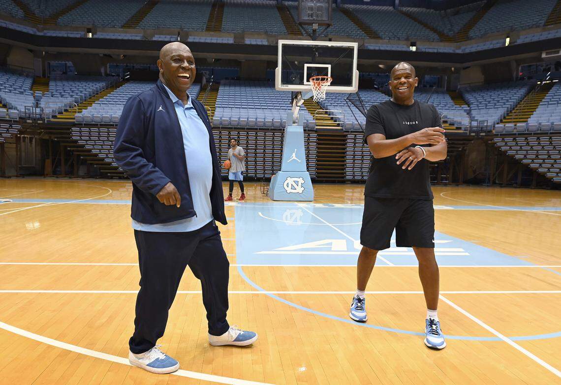 UNC Chapel Hill basketball legend Phil Ford, left, jokes with head coach Hubert Davis, right, at the Smith Center on Wednesday, June 1, 2022. UNC head coach Dean Smith used the four corners offense under Ford at point guard.