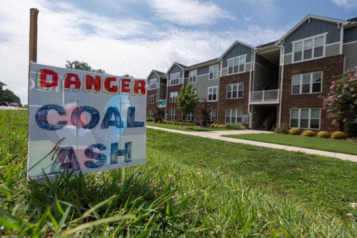 A sign outside Palisades at Waters Edge, an apartment complex near Lake Norman, warns of coal ash from the nearby Marshall Steam Station.