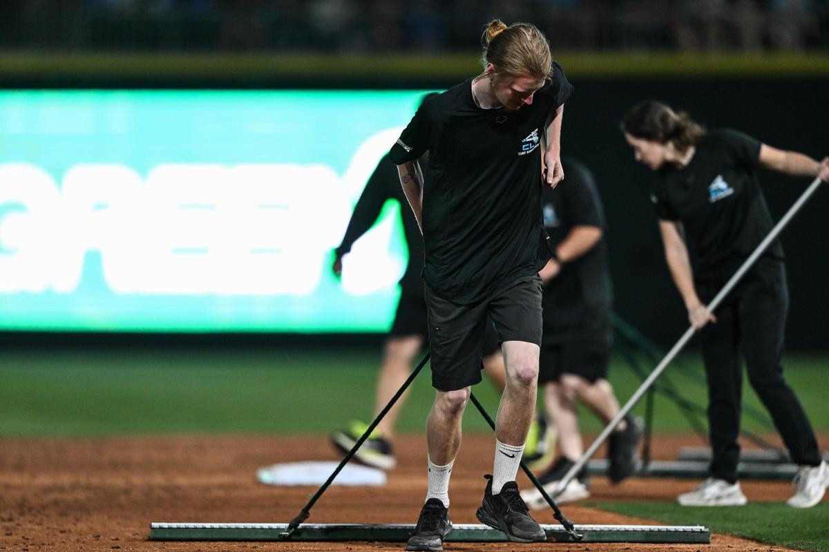 Charlotte Knights groundkeepers tend the field during a Minor League Baseball game against the Gwinnett Stripers at Truist Field, Friday, March 28, 2025, in Charlotte, N.C. (Charlotte Observer/Matt Kelley)