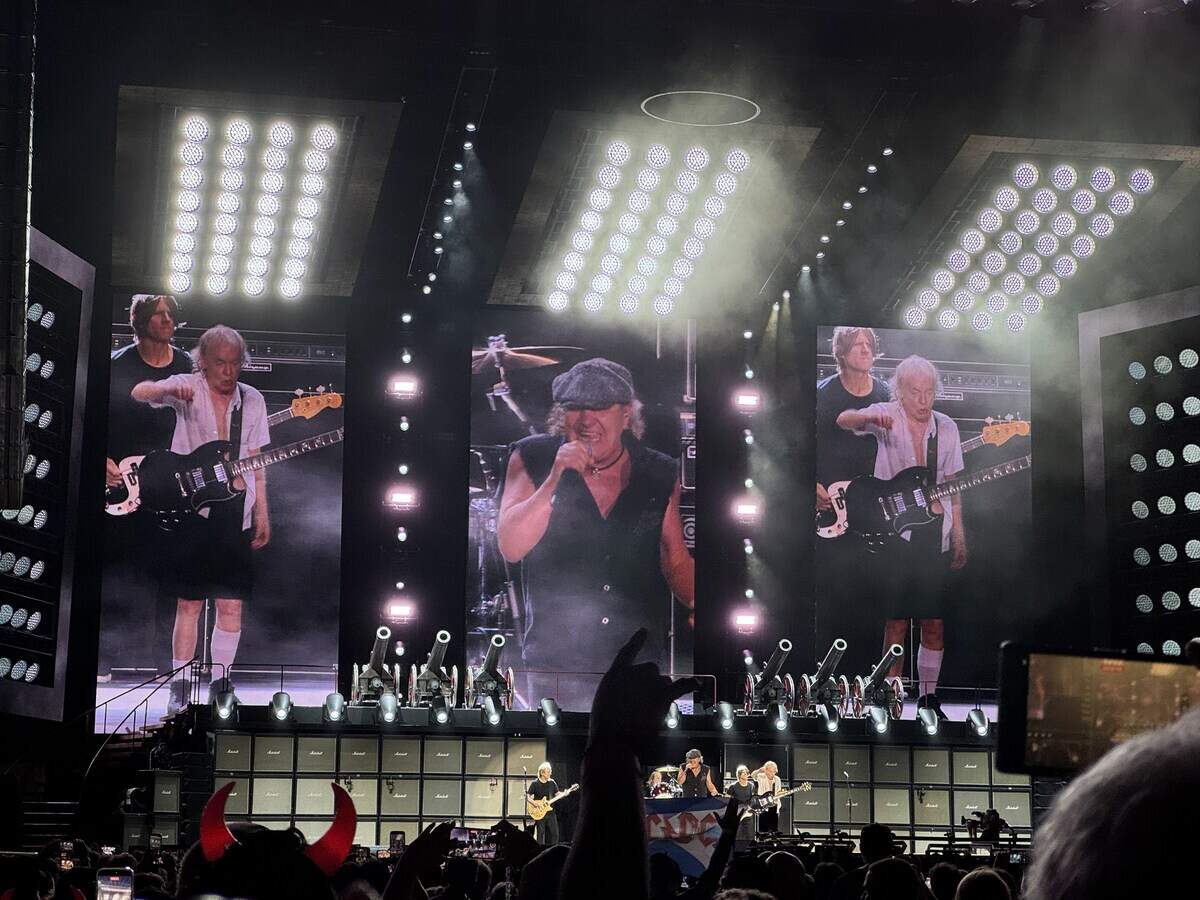 Brian Johnson, center, and Angus Young perform at Bank of America Stadium in Charlotte on Saturday night.