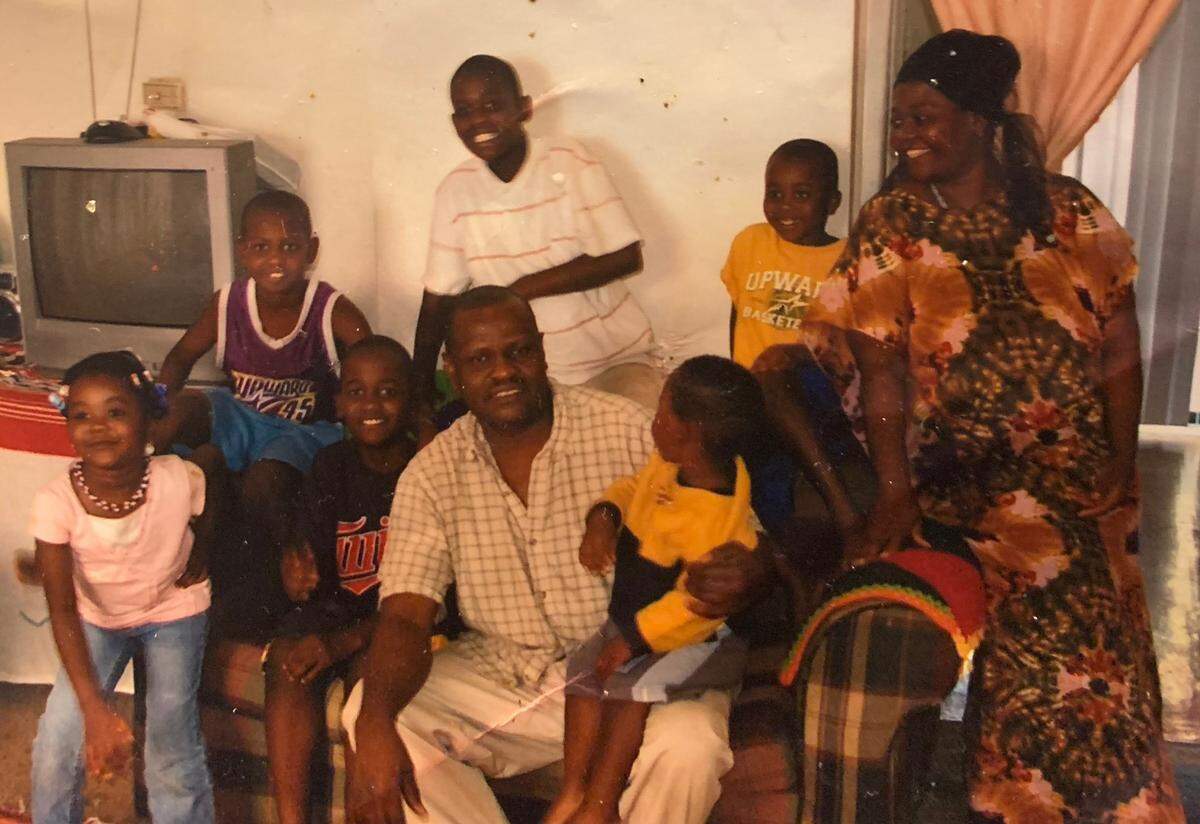 A family photo taken in 2007 at their first apartment. With Faduma are her brothers Yusuf, Ali, Abdul and Ramazani, her mother Khadija, her father Nur, who has her brother Mahamad in his lap.
