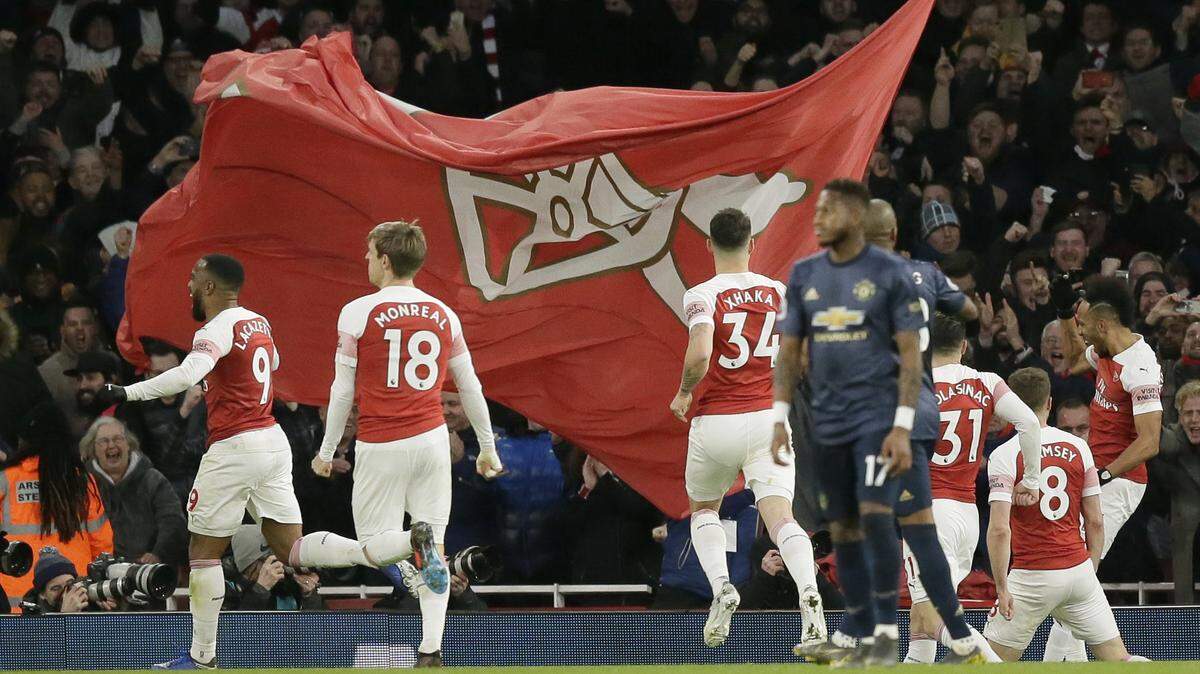 Arsenal players celebrate a goal scored during an English Premier League match against Manchester United at the Emirates Stadium in London earlier this month. Arsenal will visit Charlotte in July for the International Champion’s Cup.
