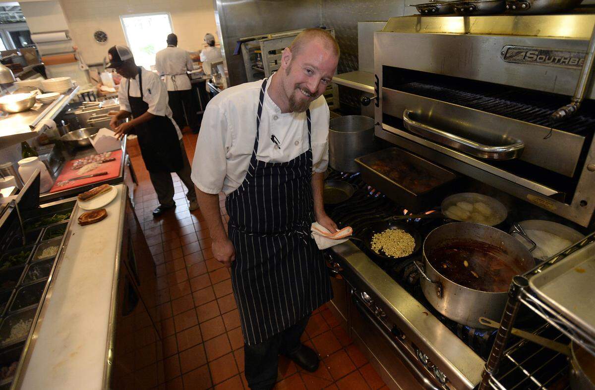 Chef Ben Philpott in the kitchen at Block & Grinder in June 2014.