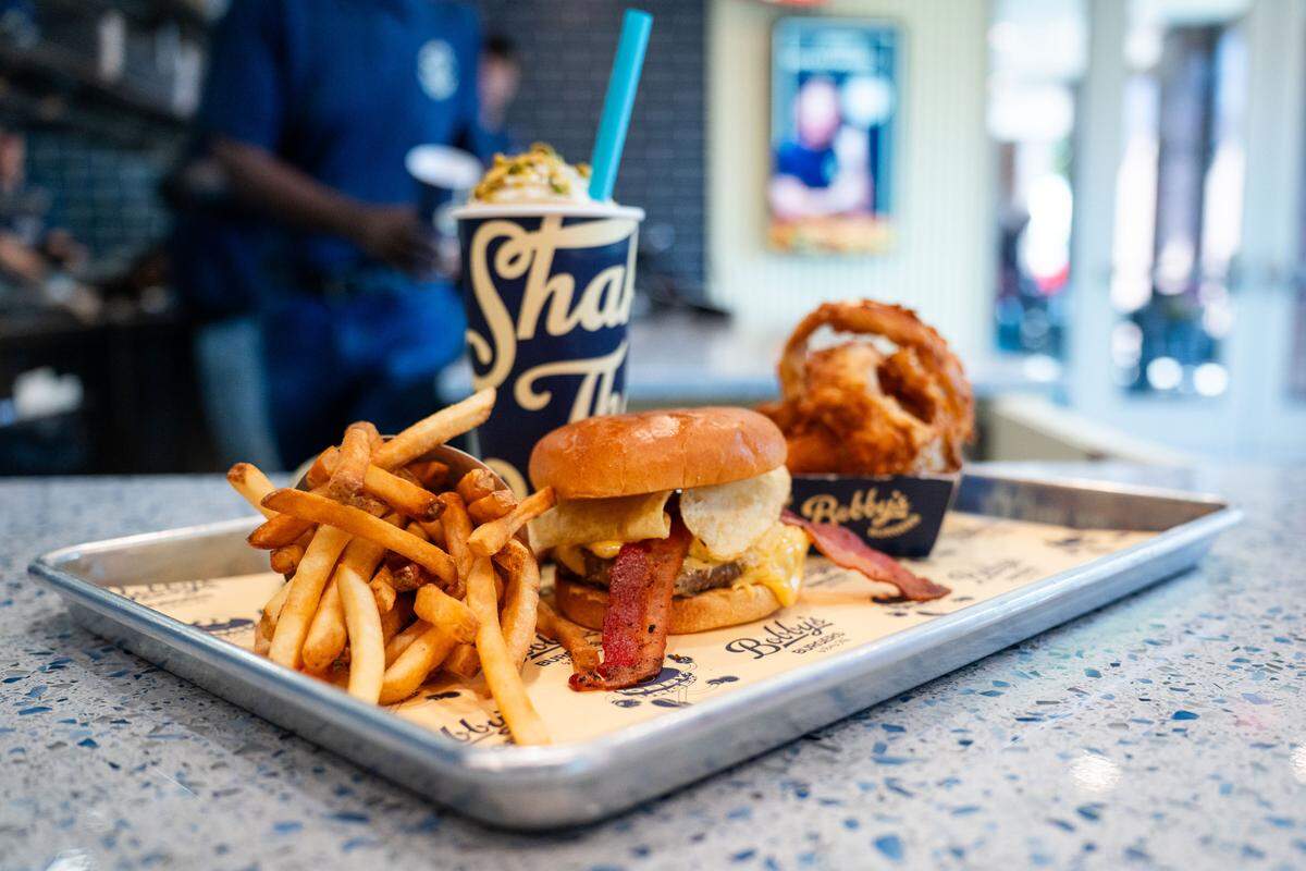 Bobby’s Burgers has a bacon crunch burger, shown here with french fries and a pistachio shake. “Well, my favorite is a bacon crunchburger — and the people that know, know the pistachio shake is the best,” Bobby Flay told CharlotteFive.