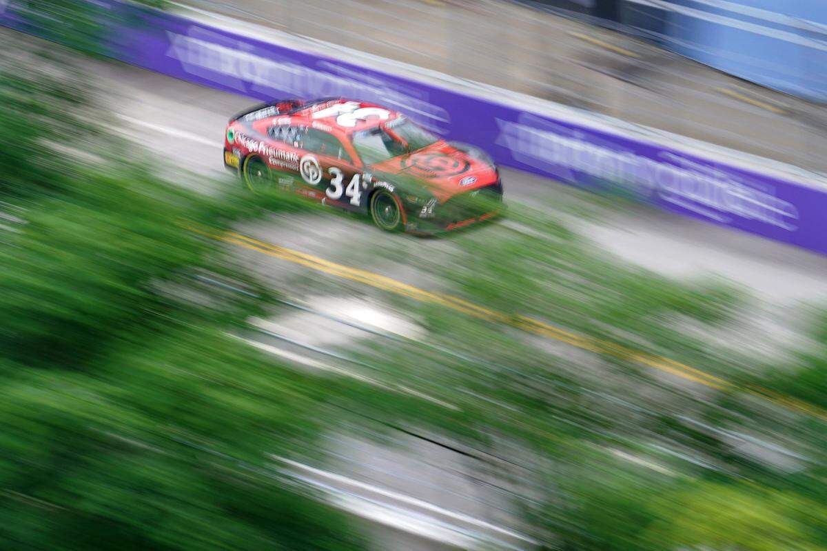 Jul 2, 2023; Chicago, Illinois, USA; NASCAR Cup Series driver Michael McDowell (34) races along Grant Park during the Grant Park 220 of the Chicago Street Race viewed from the eRacing Association turn 7 Skydeck at Venue Six10. Mandatory Credit: Jon Durr-USA TODAY Sports