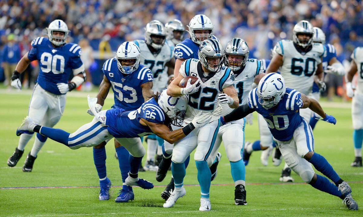 Carolina Panthers running back Christian McCaffrey, center, is surrounded by Indianapolis Colts defense on a run during second quarter action at Lucas Oil Stadium in Indianapolis, Indiana on Dec. 22, 2019.