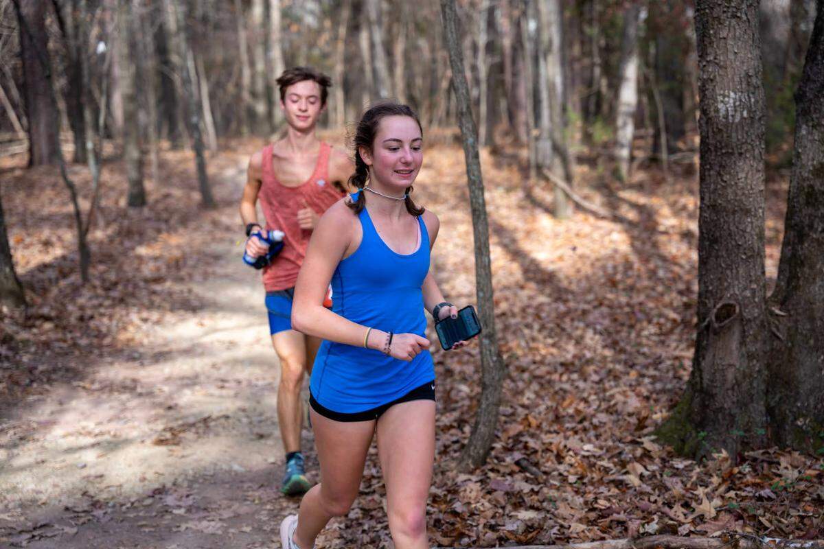 Evie Thornton runs ahead of her brother Owen during the Unico 100.