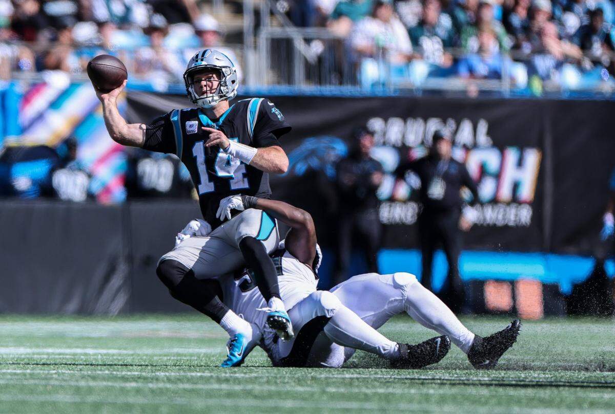 Carolina Panthers quarterback Sam Darnold, left, is sacked by Philadelphia Eagles Javon Hargrave at the Bank of America Stadium in Charlotte, N.C., on Sunday, October 10, 2021.