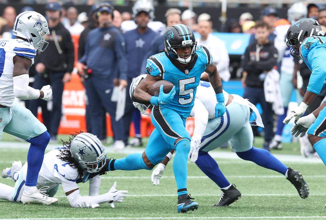 Carolina Panthers running back Rico Dowdle, center, rushes up the middle against the Dallas Cowboys defense for yardage during action on Sunday, October 12, 2025 at Bank of America Stadium. The Panthers defeated the Cowboys 30-27.