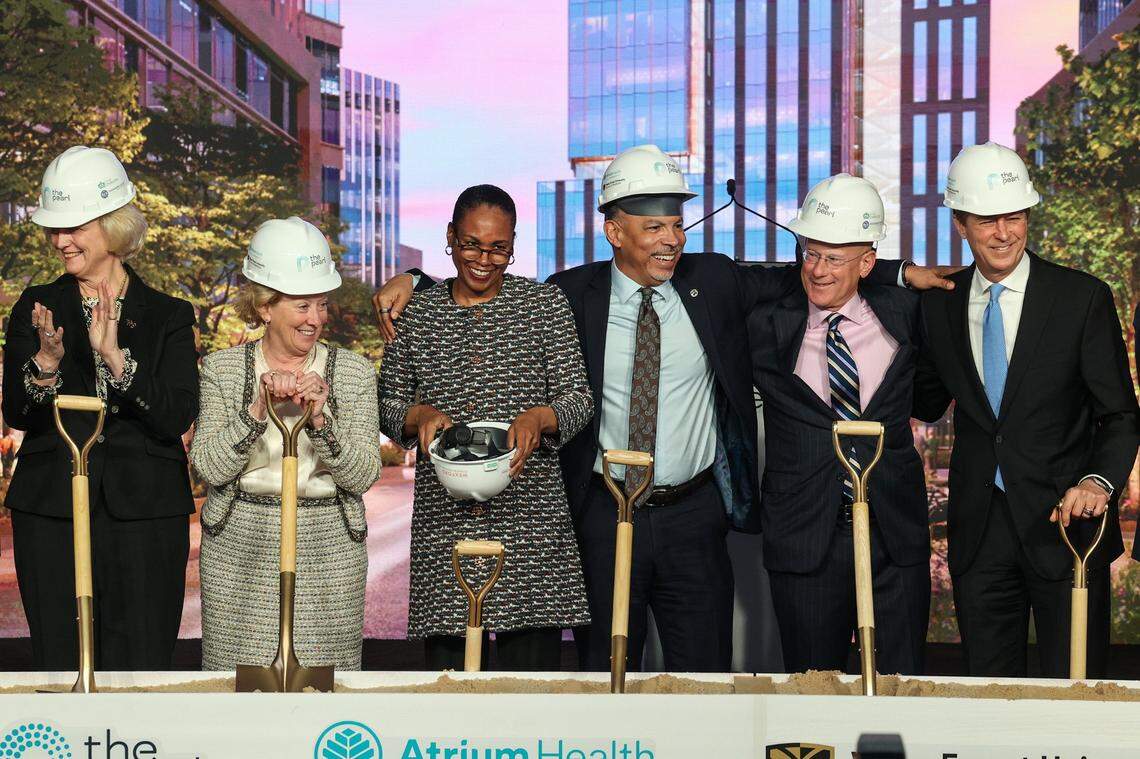 Several officials, including the new dean of Wake Forest School of Medicine Dr. Ebony Boulware, third from left, and president and chief executive officer of Atrium Health, Gene Woods, third from right, attend the groundbreaking ceremony for Wake Forest University School of Medicine - Charlotte and The Pearl district in January 2023.