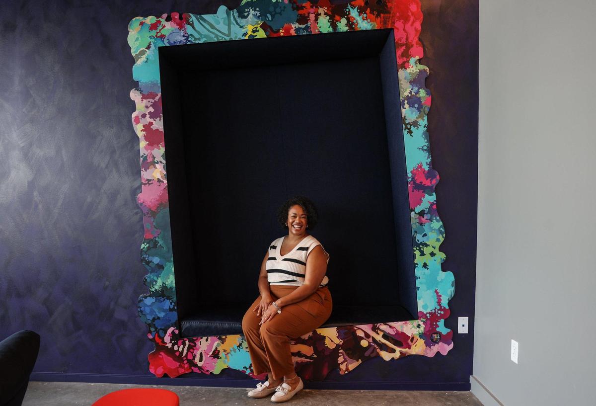 Giovanna Kannady, director of Sales and Marketing for Moxy Charlotte Downtown, sits in one of the photogenic spaces created for social posts.