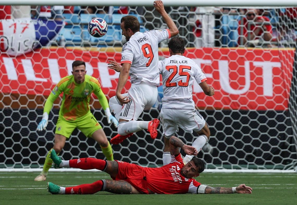 Bayern München’s forward Harry Kane, center, leaps over S.L. Benfica’s defender Nicolas Otamendi as he charges the goal during the FIFA Club World Cup at Bank of America Stadium in Charlotte, NC on Tuesday, June 24, 2025.