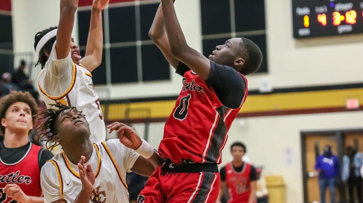 Butlers Terrance Badio powered over West Charlotte defense to score two in the Charlotte Hoops Challenge at Harding high school in Charlotte NC on Nov 30, 2024