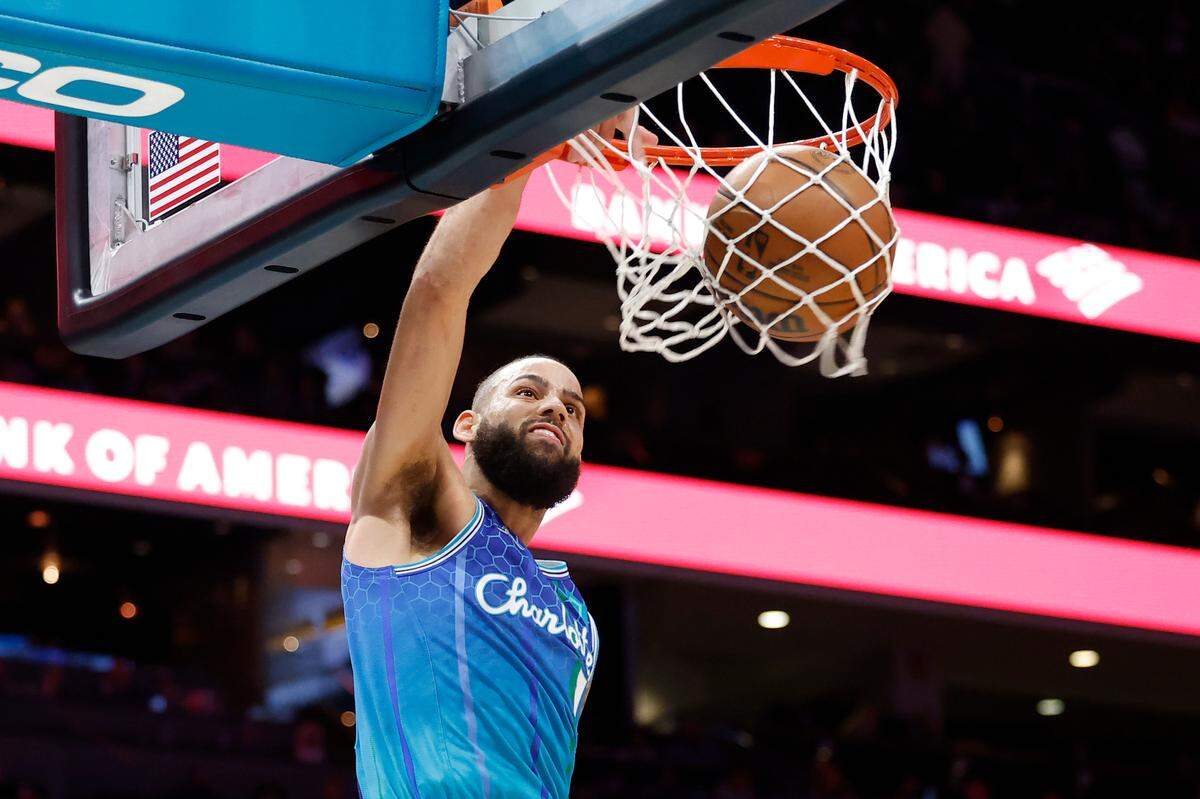 Charlotte Hornets forward Cody Martin (11) slam dunks the ball over Dallas Mavericks defense during a game at Spectrum Center in Charlotte, N.C., Saturday, March 19, 2022. Charlotte beat Dallas 129-108.