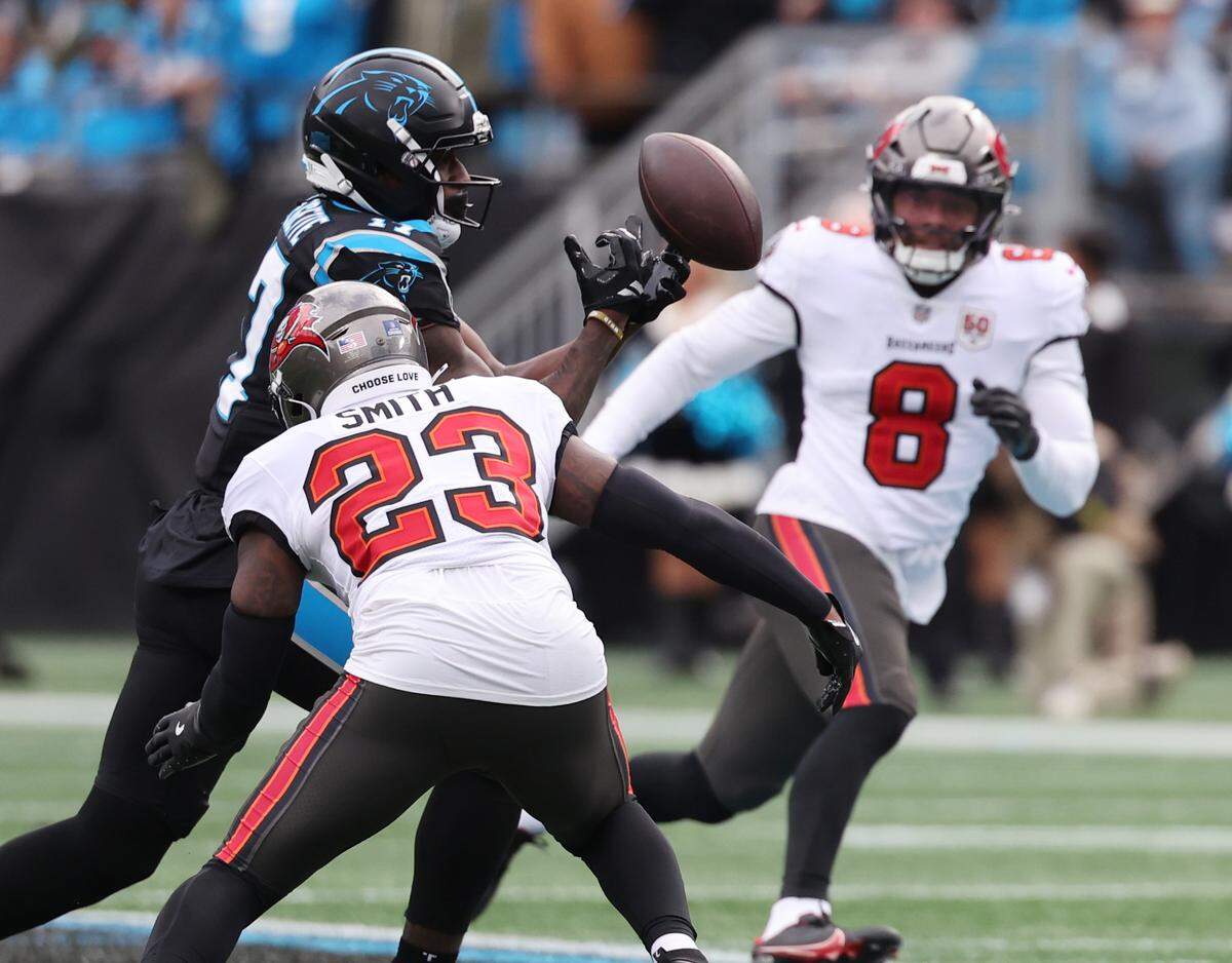 Carolina Panthers Xavier Legette loses control of the ball as Tampa Bay Buccaneers Tykee Smith leans in for the tackle at Bank of America Stadium in Charlotte