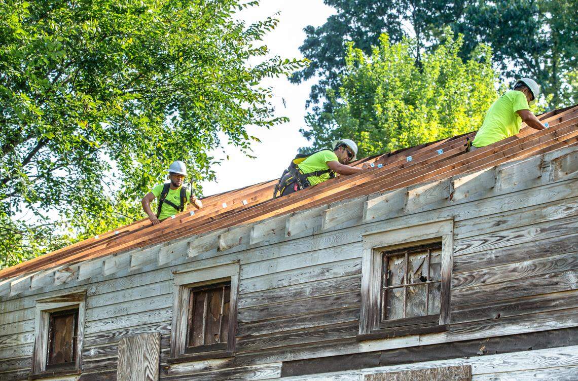 Crews remove the roof from the historic Siloam School ahead of its transport to the Charlotte Museum of History where it was restored.