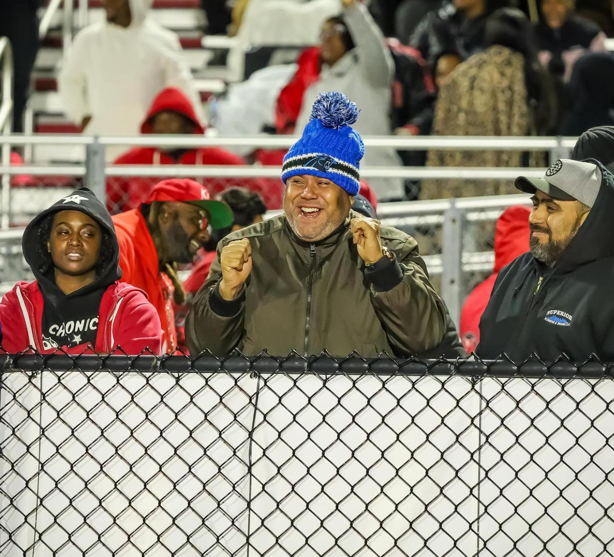 Monroe fans celebrate as their team takes a huge lead over Brevard at the NCHSAA 2A Western Regional championship game at Monroe high school in Monroe NC on Friday December 13th
