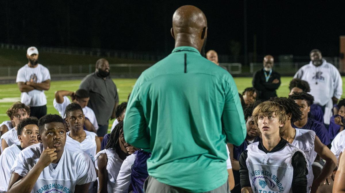 Palisades High School Pumas football coach Jonathan Simmons delivers a speech to close out the first season practice at Palisades High School in Charlotte, N.C, which they began just after midnight on Aug. 1, 2022.