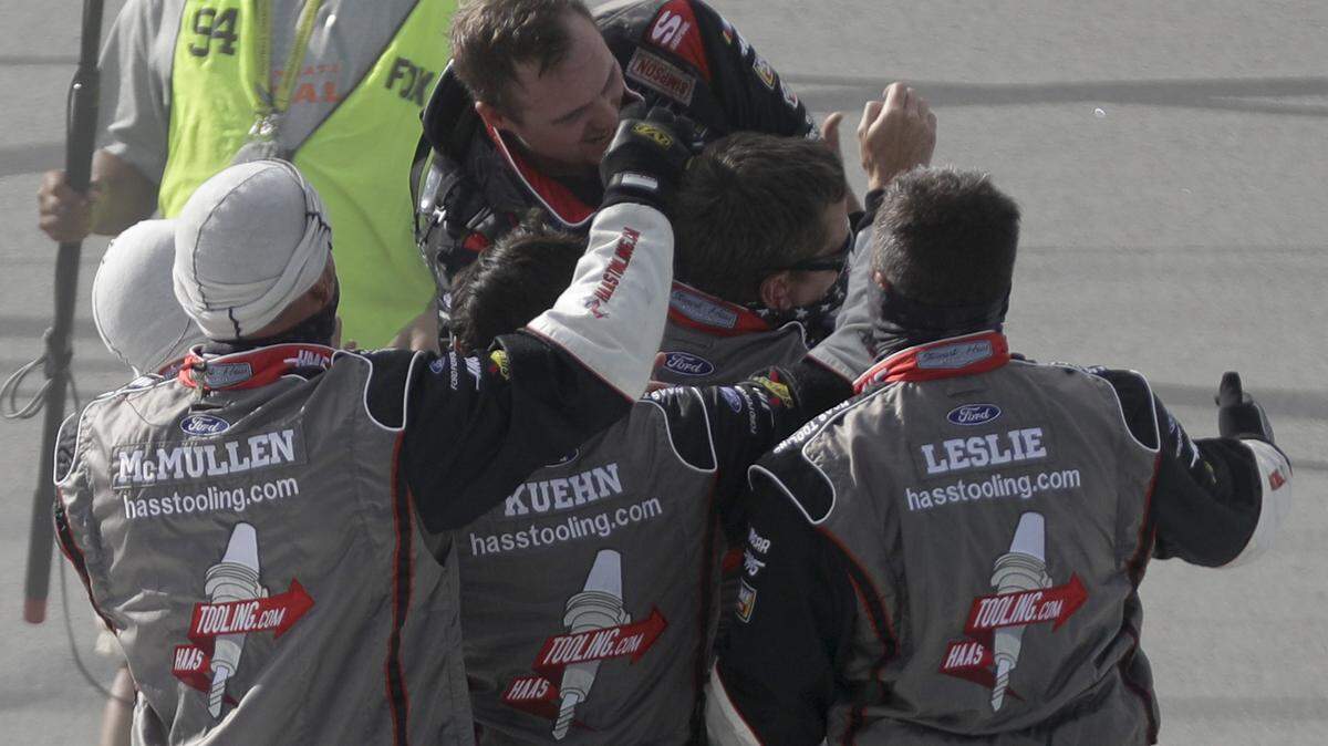 Cole Custer, top, celebrates with his crew after winning a NASCAR Cup Series auto race Sunday, July 12, 2020, in Sparta, Ky. (AP Photo/Mark Humphrey)