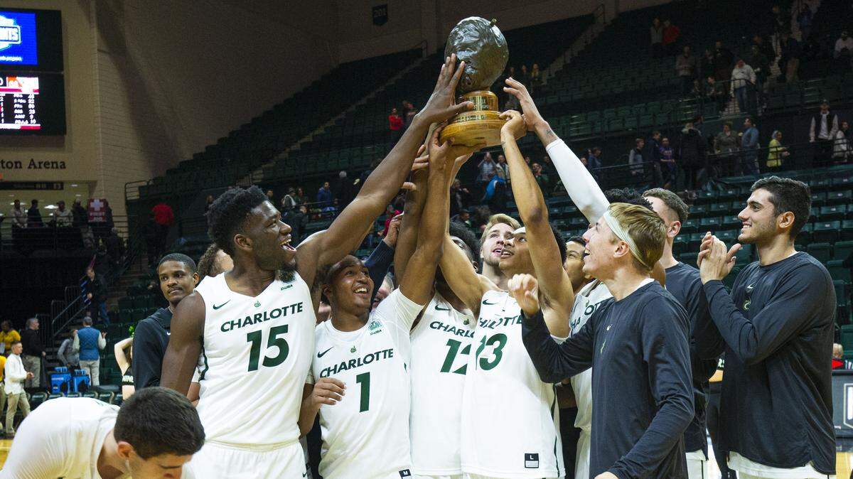 The Charlotte 49ers hold up the “Battle for the Hornets’ Nest” trophy after beating Davidson 71-58 at the Halton Arena in Charlotte on Friday, November 12, 2019.