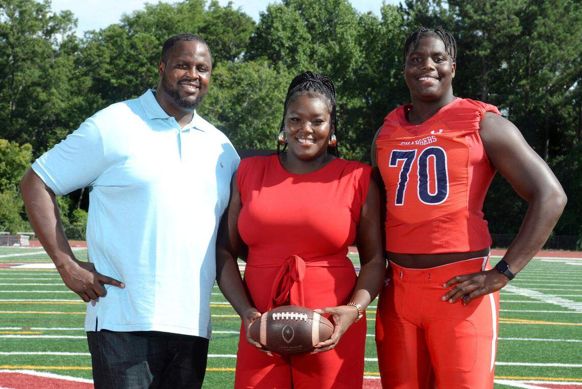 Providence Day offensive lineman David Sanders, right, with his parents, David Sanders Sr., left and mother Samantha Sanders, center. David Sanders is perhaps the best high school football player in America. He plans to announce his college decision on Saturday, August 17, 2024.