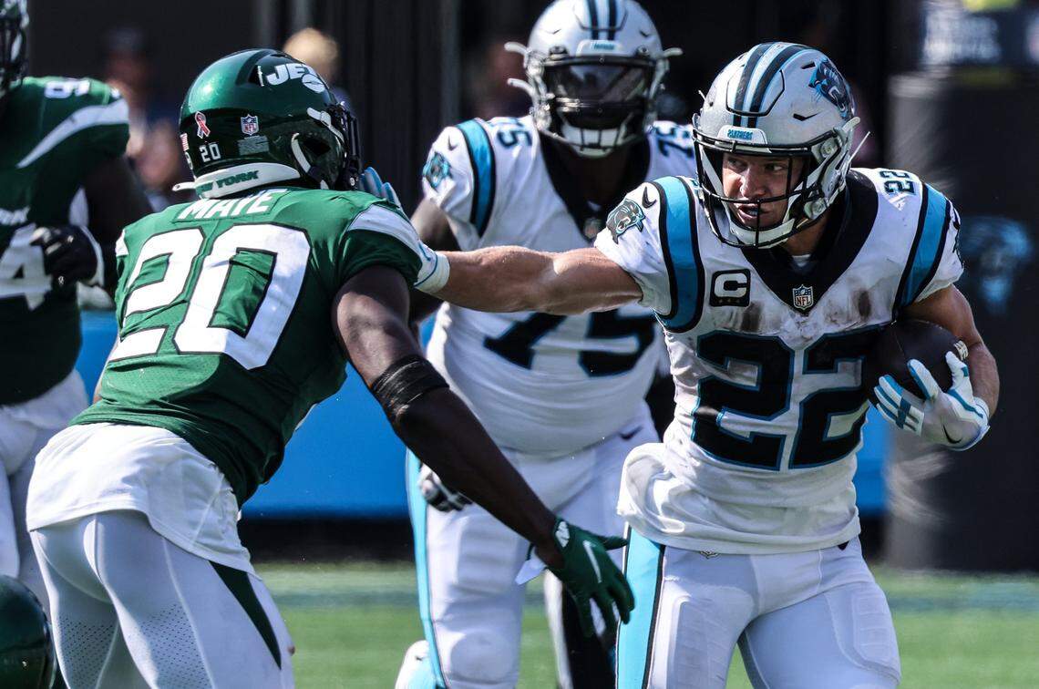 Carolina Panthers Christian McCaffrey, left, stiff arms New York Jets Marcus Maye at the Bank of America Stadium in Charlotte, N.C., on Sunday, September 12, 2021.