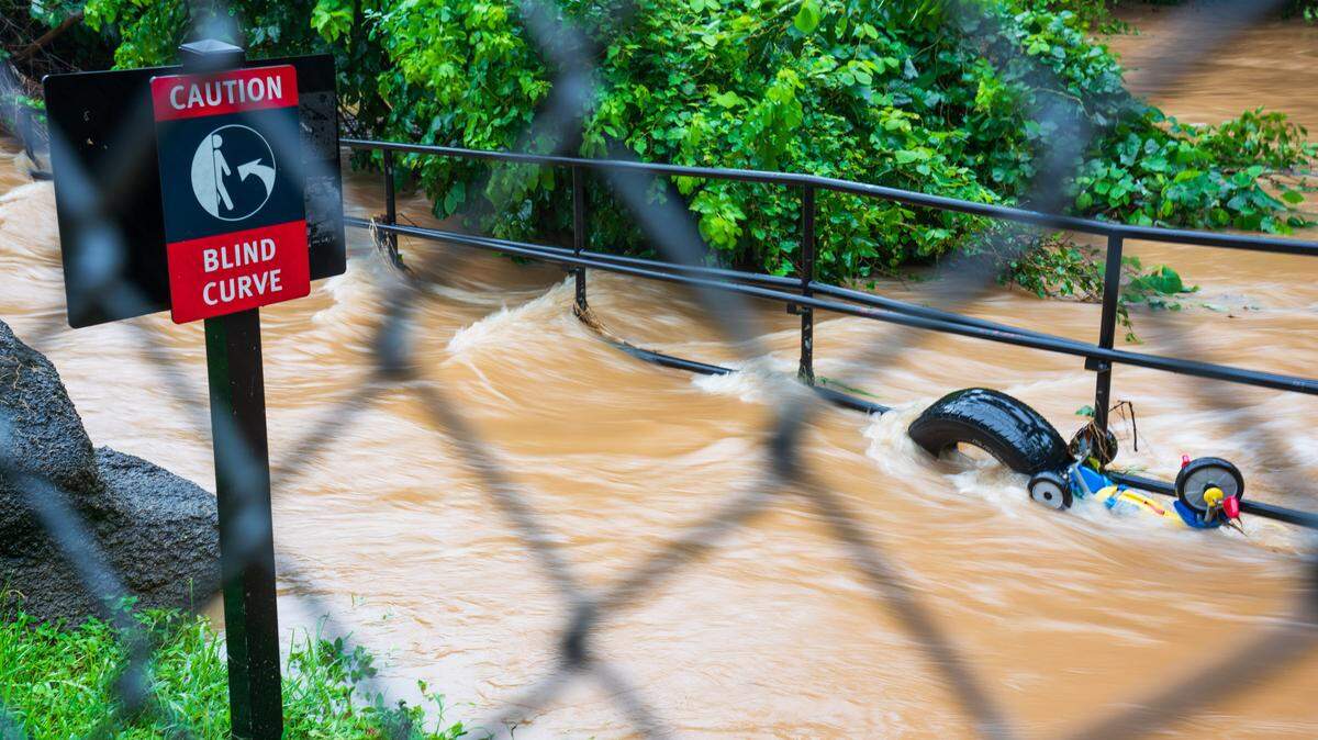 Water rushes through at The Greenway entrance at Freedom Park in Charlotte, NC on Thursday, August 8, 2024 as heavy rains from Tropical Storm Debby passes through the area.