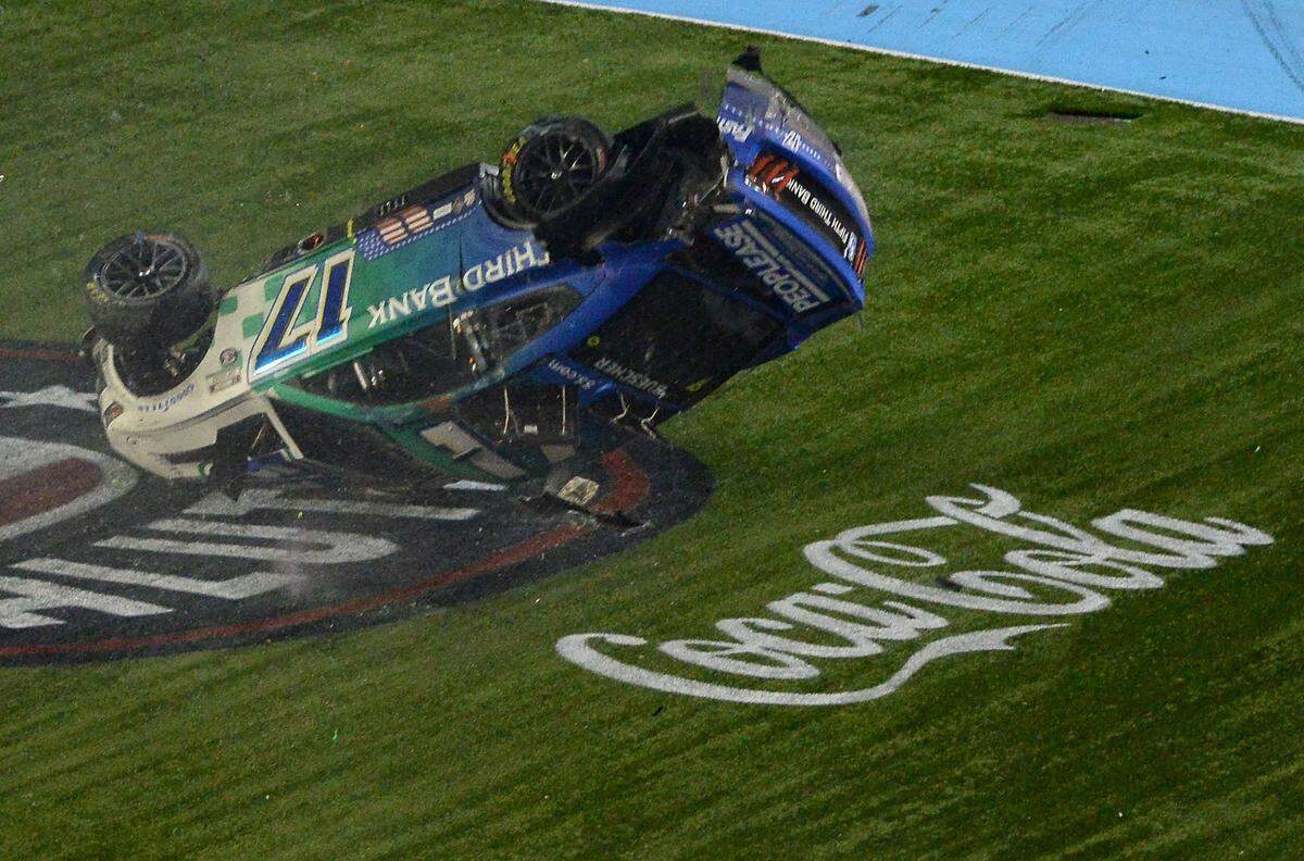NASCAR drivers Chris Bueschers (17) car begins to flip after he and driver Daniel Suarez (99), wrecked after crossing the start/finish line during the Coca-Cola 600 at Charlotte Motor Speedway on Sunday, May 29, 2022. Buescher would flip down the front stretch before coming to rest on the roof of the car.