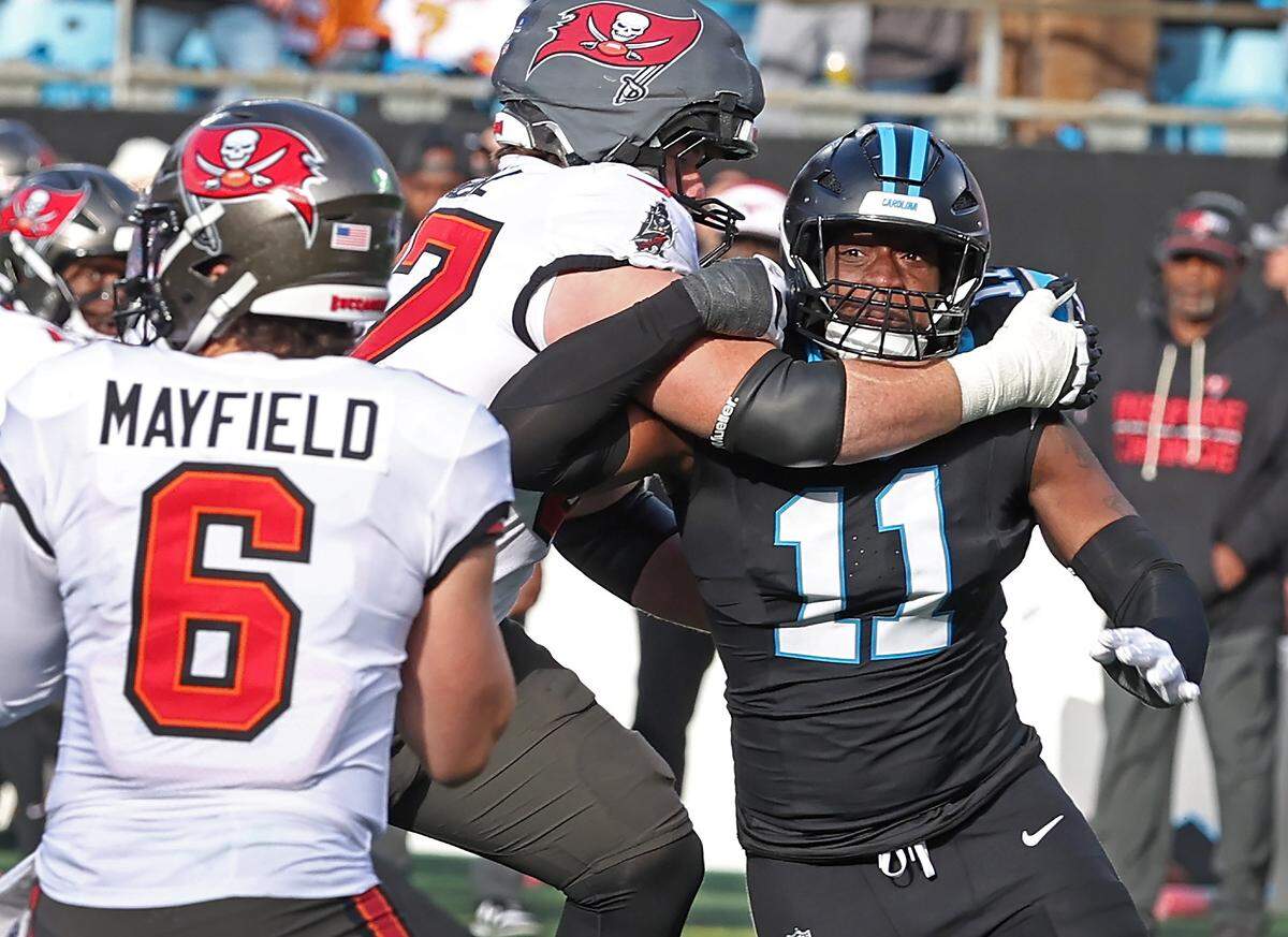 Carolina Panthers linebacker Nic Scourton, right, rushes around the end toward Tampa Bay Buccaneers quarterback Baker Mayfield, left, during action on Sunday, December 21, 2025 at Bank of America Stadium in Charlotte, NC. The Panthers defeated the Buccaneers 23-20.
