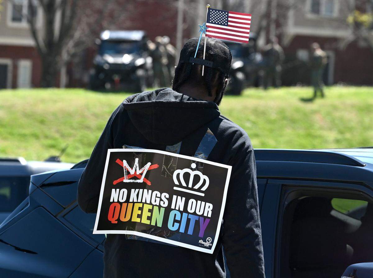 A protester's sign speaks to Charlotte, NC being the Queen City during a No Kings rally at First Ward Park on Saturday, March 28, 2026.