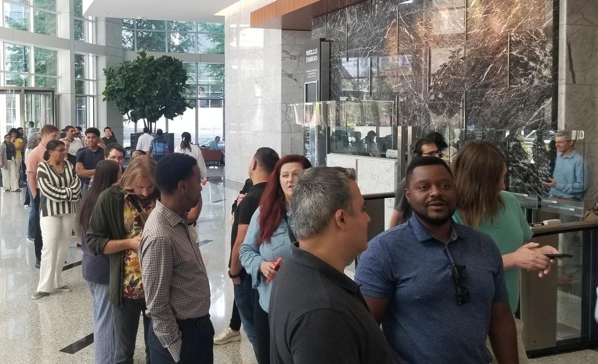 Wells Fargo employees line up to get meals from the new food hall at the 550 S. Tryon building in uptown.