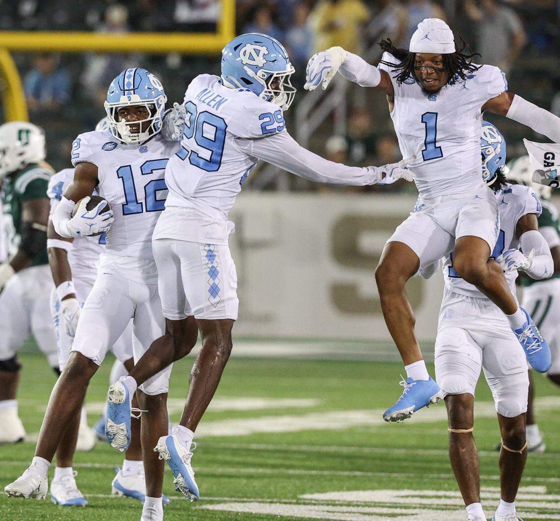 UNC defensive back Greg Smith, far left, celebrates an interception with teammates Marcus Allen, center, and Thaddeus Dixon during a 2025 game against Charlotte at Jerry Richardson Stadium. UNC held the 49ers to zero touchdowns, and won the game 20-3.