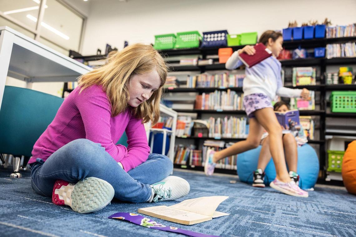 Camren McAuley reads a book in the media center at Lake Norman Charter Elementary School in Huntersville, N.C., on Thursday, September 8, 2022.