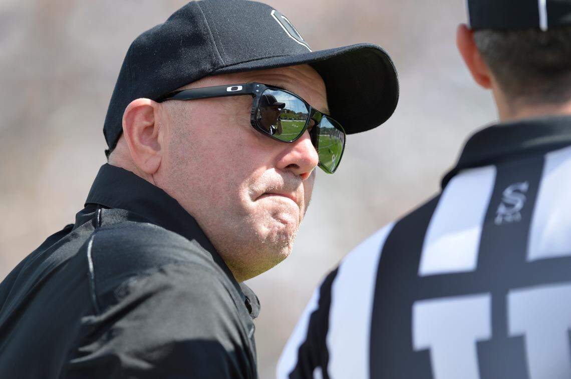 Ohio Bobcats head coach Tim Albin talks with an official during the first quarter against the Iowa State Cyclones at Peden Stadium in September 2023.